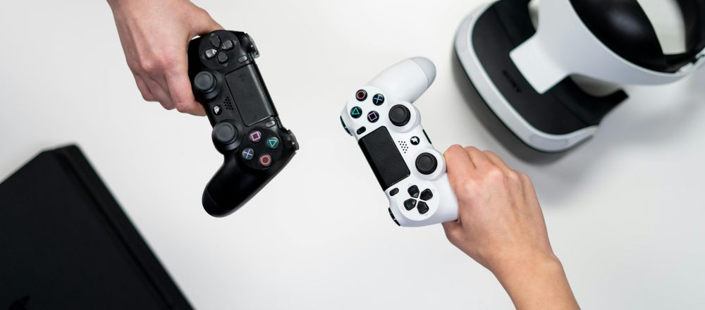 Two hands holding video game console controllers
